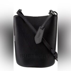 Chic leather crossbody by Burberry. Features textured finish & adjustable strap.